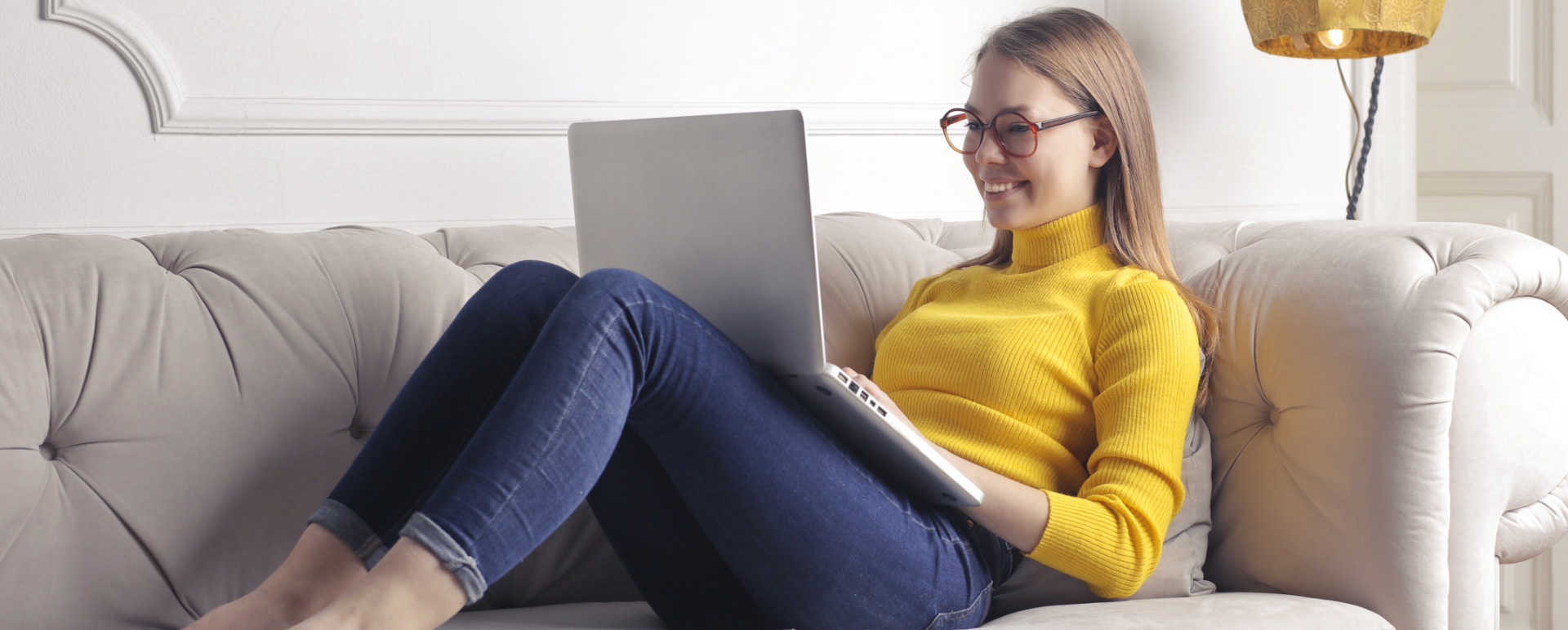 Image of a woman lying down with a notebook on her lap.